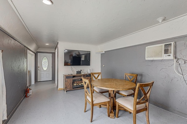 dining room featuring a wall mounted AC