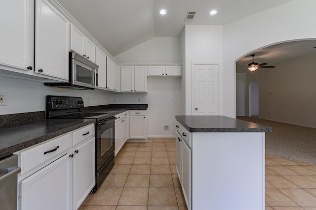 kitchen featuring white cabinetry, ceiling fan, stainless steel appliances, and a kitchen island