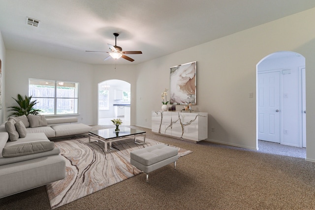 carpeted living room with ceiling fan