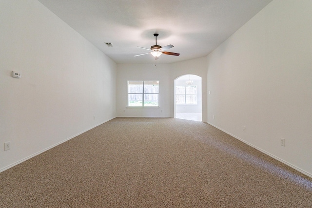 carpeted spare room featuring ceiling fan