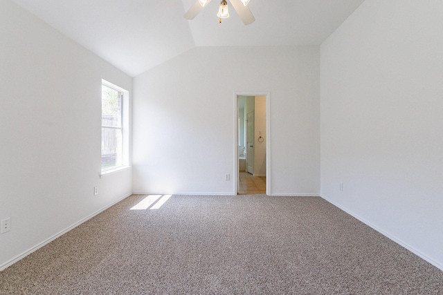 carpeted empty room featuring ceiling fan and lofted ceiling