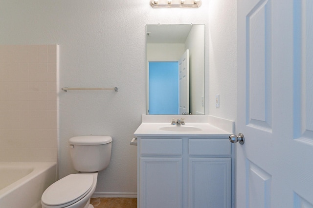 bathroom featuring vanity, tile patterned flooring, and toilet