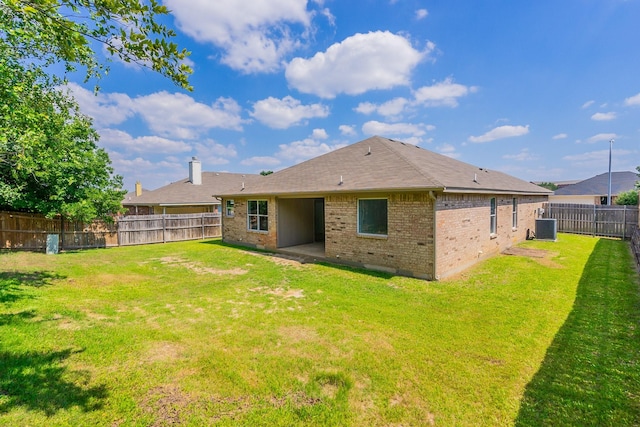 rear view of house featuring a patio area, central AC unit, and a lawn