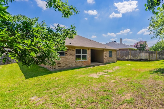 back of house with a lawn