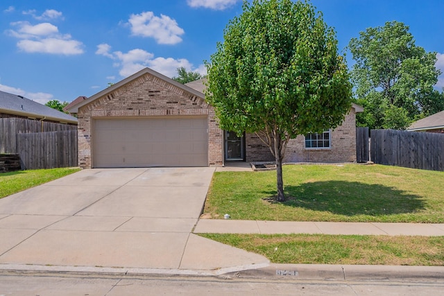 view of front of property with a garage and a front yard