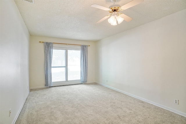 carpeted empty room with a textured ceiling and ceiling fan