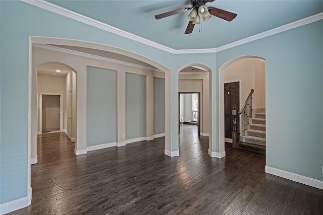 empty room featuring dark hardwood / wood-style flooring, ceiling fan, and ornamental molding