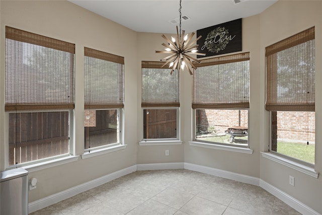 unfurnished sunroom with a chandelier