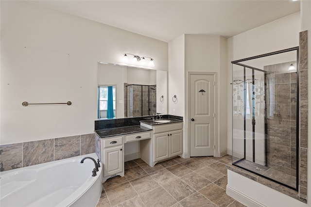 bathroom featuring vanity and independent shower and bath