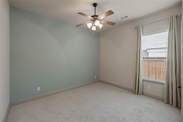 carpeted spare room featuring ceiling fan