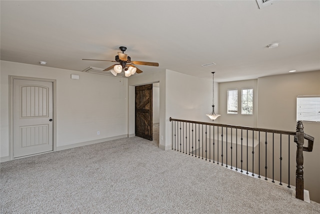 carpeted empty room featuring ceiling fan