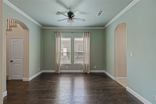 spare room featuring crown molding, ceiling fan, and dark wood-type flooring