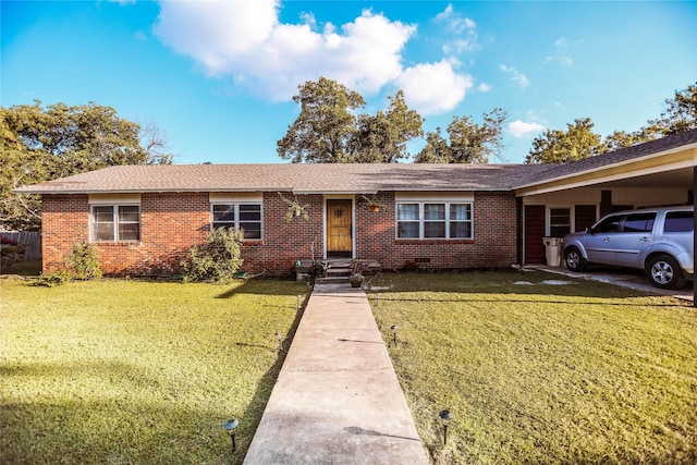 ranch-style home featuring a front lawn and a carport