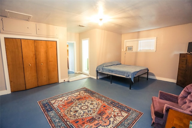 bedroom with concrete flooring and a closet