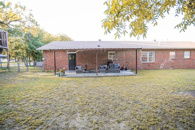 back of house featuring a patio area, an outdoor hangout area, and a yard