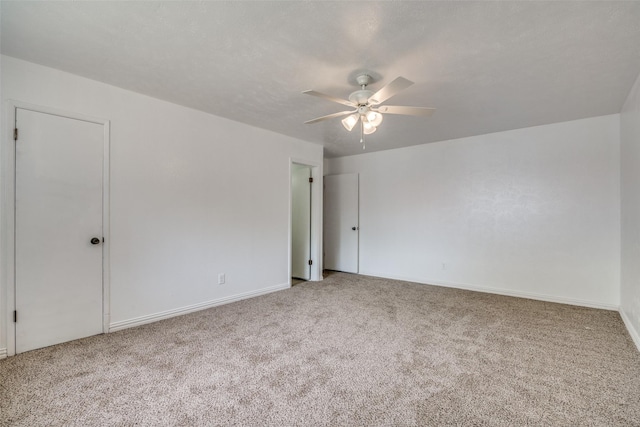 unfurnished room featuring ceiling fan and carpet floors