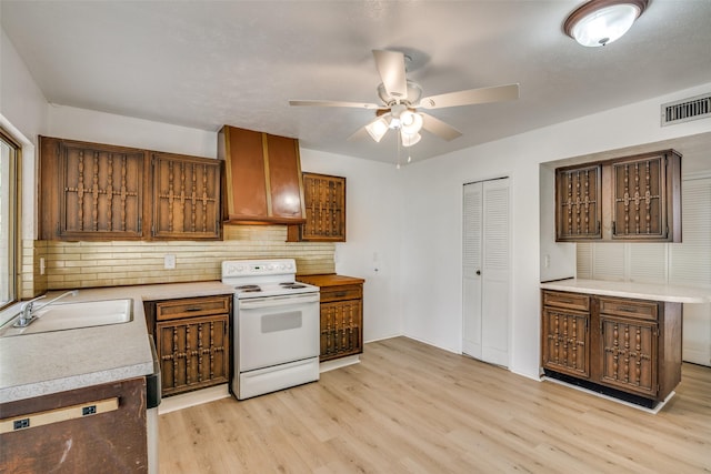 kitchen with sink, ceiling fan, white electric range oven, decorative backsplash, and light wood-type flooring