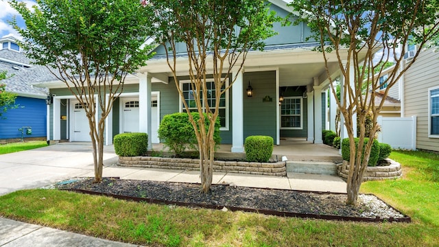 view of front of home with covered porch and a garage