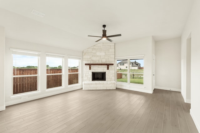 unfurnished living room with lofted ceiling, ceiling fan, a fireplace, and hardwood / wood-style floors