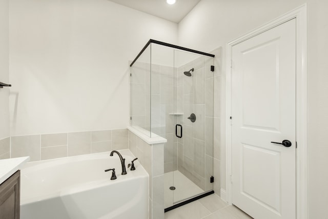 bathroom featuring independent shower and bath, vanity, and tile patterned floors