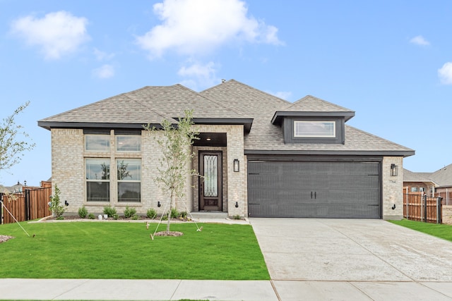 view of front of property featuring a garage and a front lawn