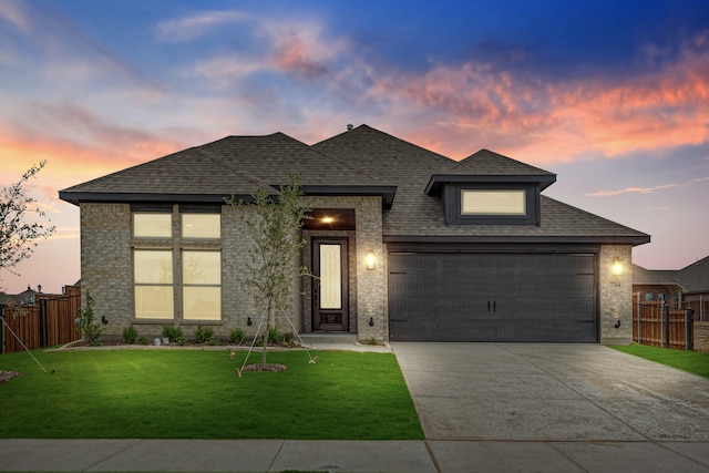 view of front of home with a lawn and a garage