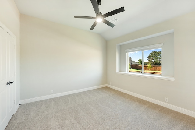 unfurnished room with lofted ceiling, light colored carpet, and ceiling fan