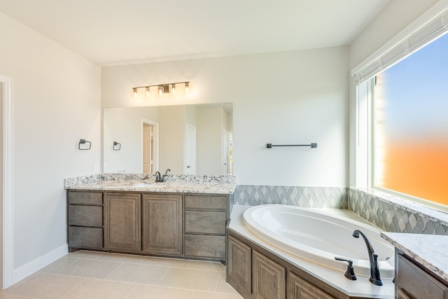 bathroom featuring vanity, a washtub, and tile patterned flooring