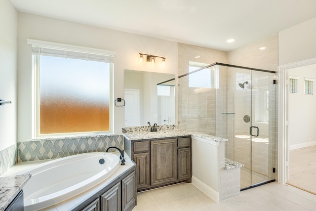 bathroom featuring tile patterned floors, a shower stall, a bath, and vanity