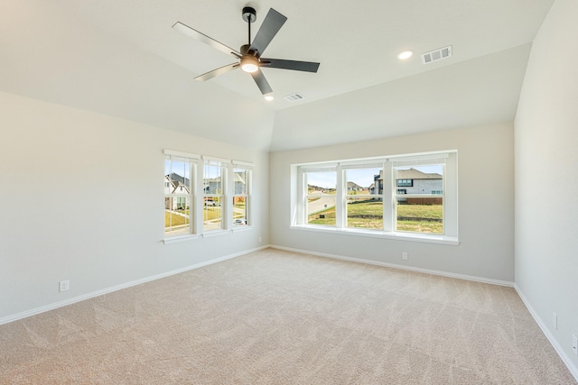 empty room with light colored carpet, ceiling fan, and visible vents