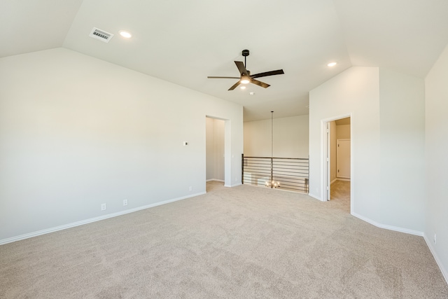 unfurnished room featuring ceiling fan, light colored carpet, and vaulted ceiling