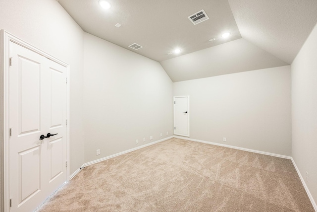 bonus room with visible vents, recessed lighting, and light colored carpet