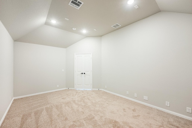 unfurnished room featuring recessed lighting, carpet flooring, lofted ceiling, and visible vents