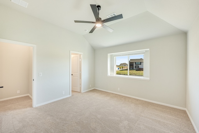 unfurnished bedroom with ceiling fan, lofted ceiling, and light colored carpet