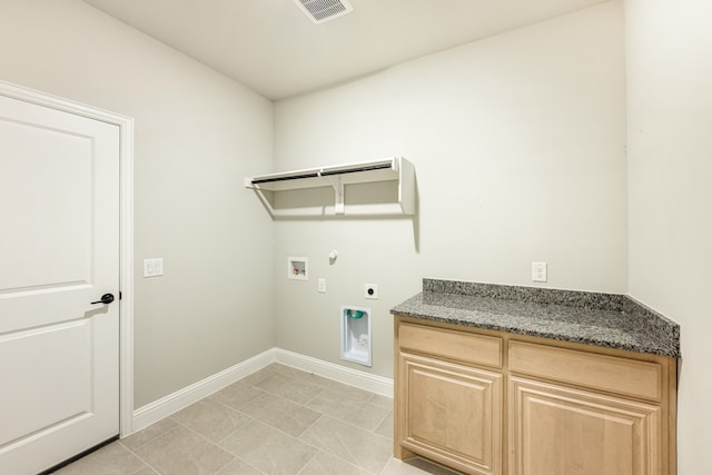 washroom with hookup for a washing machine, hookup for an electric dryer, gas dryer hookup, cabinets, and light tile patterned floors