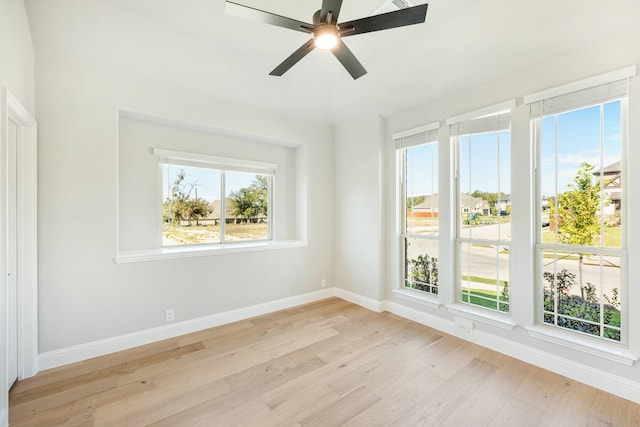 unfurnished room featuring baseboards, ceiling fan, and light wood-type flooring