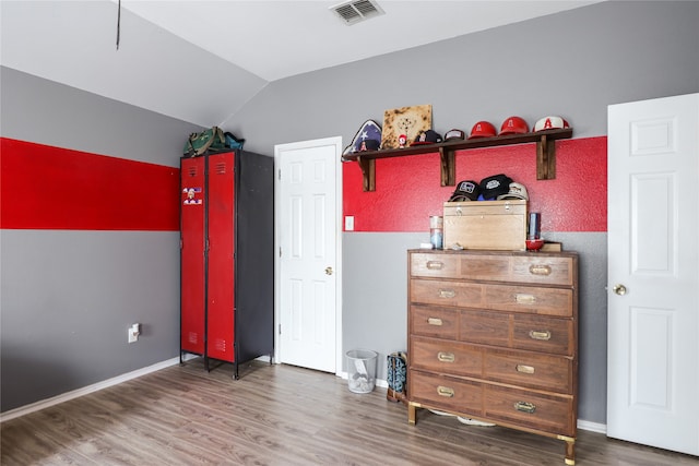 bedroom featuring lofted ceiling and dark wood-type flooring