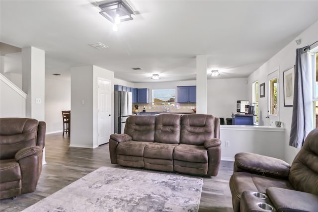 living room featuring sink and hardwood / wood-style floors