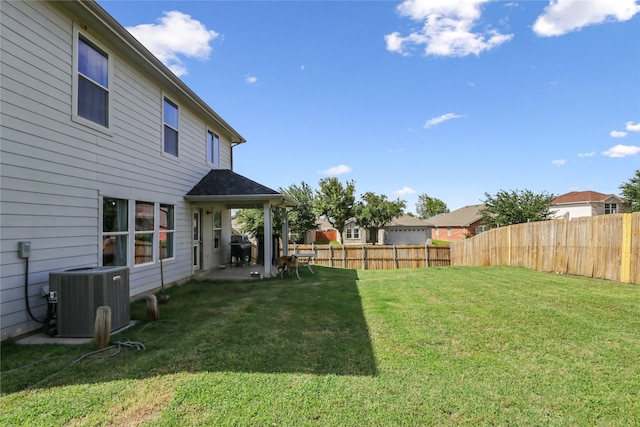 view of yard with cooling unit and a patio area