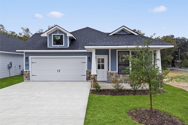 view of front of house with a front yard and a garage