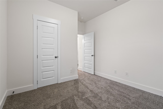 unfurnished bedroom with carpet floors and a closet