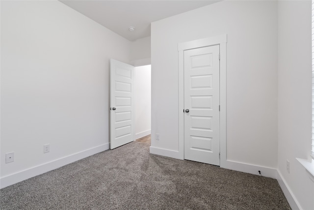 unfurnished bedroom featuring carpet flooring and a closet