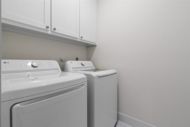 laundry room with cabinets and washer and dryer