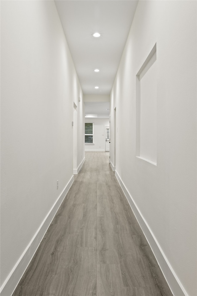 corridor with hardwood / wood-style floors