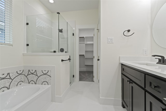 bathroom featuring tile patterned floors, vanity, and independent shower and bath