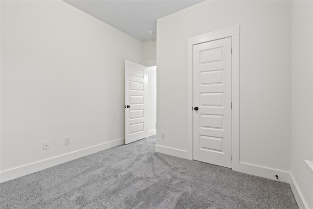 unfurnished bedroom featuring carpet and a closet