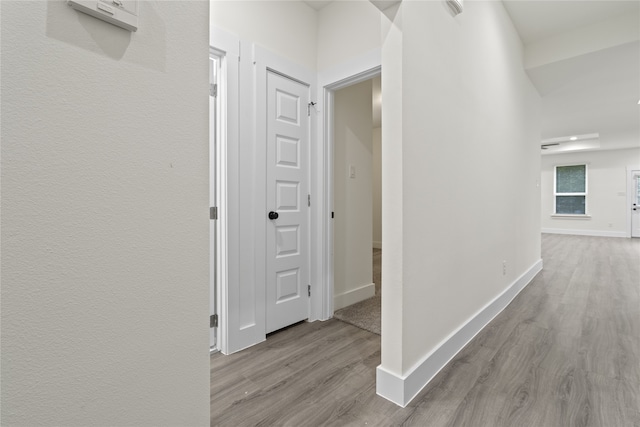 corridor with light wood-type flooring