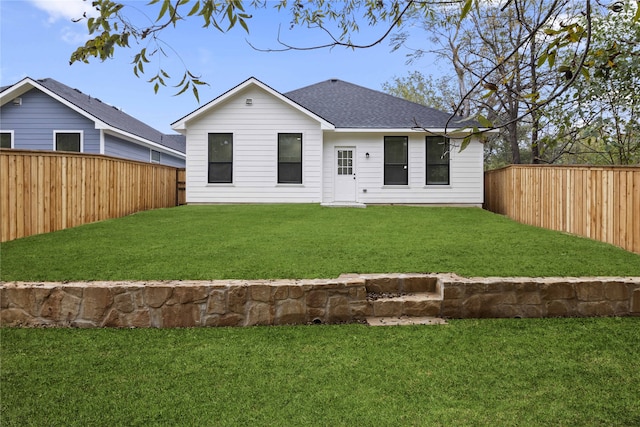 rear view of property with a lawn