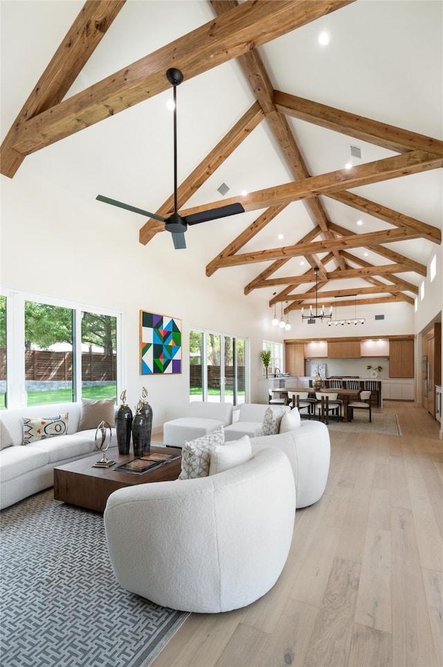 living room with beam ceiling, light hardwood / wood-style floors, and high vaulted ceiling