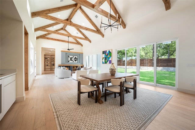 dining area with beamed ceiling, light hardwood / wood-style flooring, a notable chandelier, and high vaulted ceiling